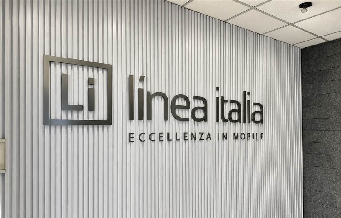 Recepción de Línea Italia con letrero metálico